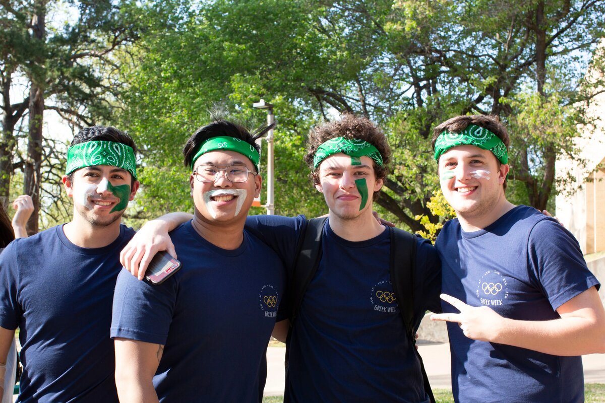Four greek life members with face paint