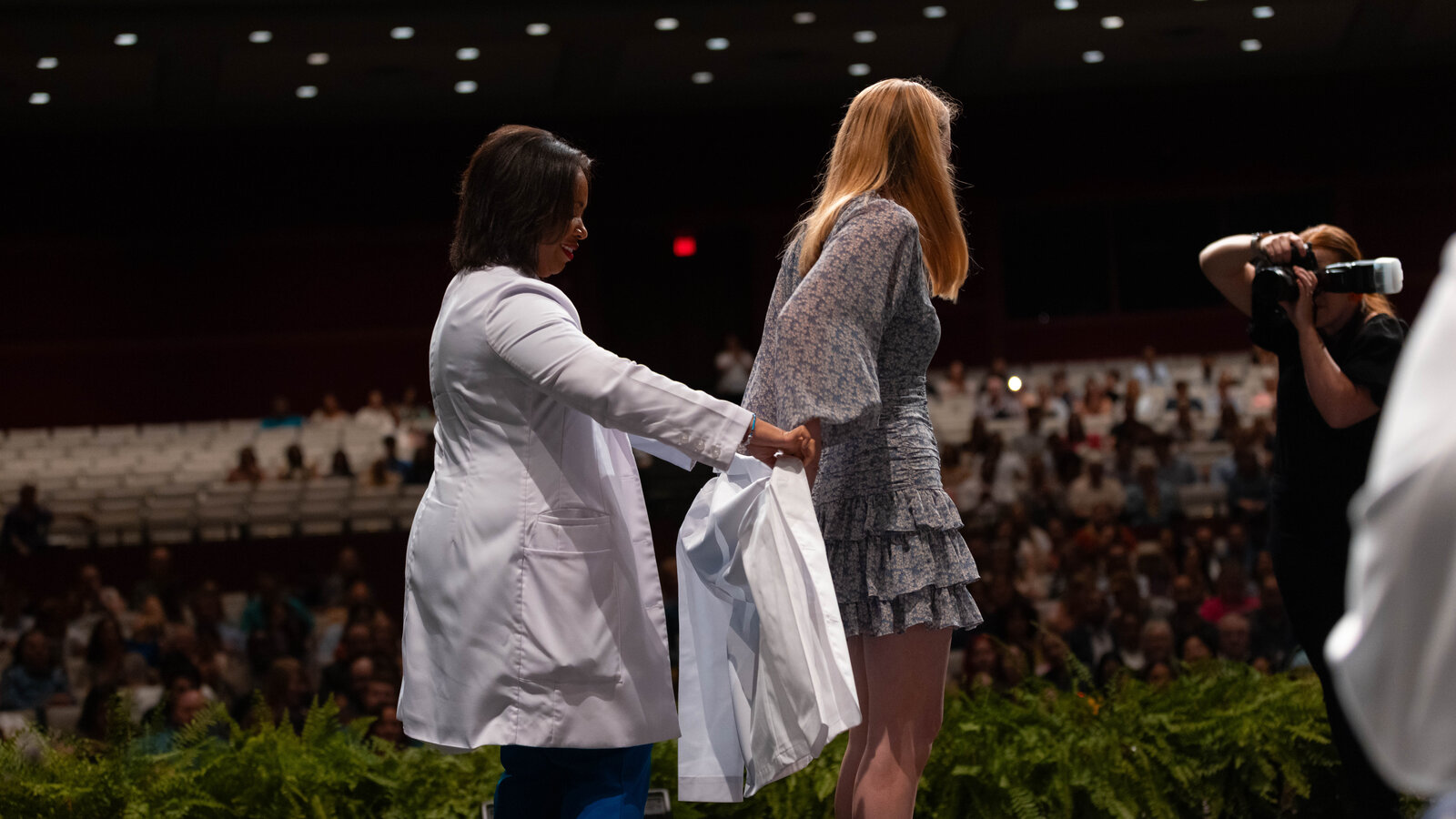 Student receives her white coat at the inaugural School of Medicine white coat ceremony
