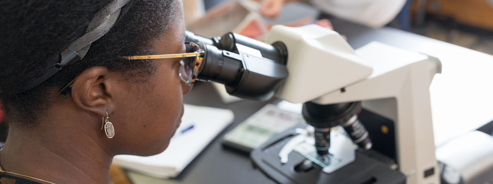 Biology student using a microscope