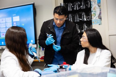 A teacher instructing two students