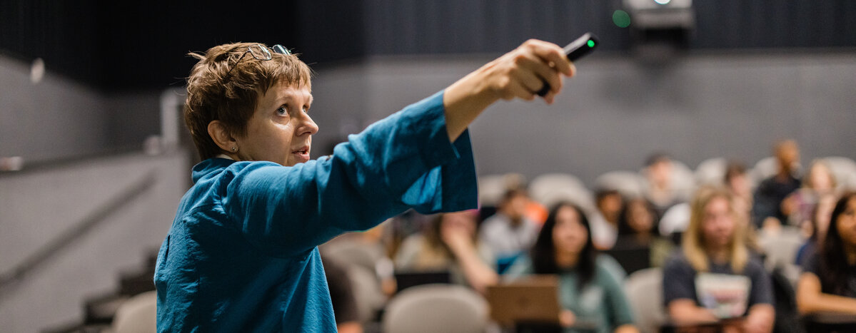 A female lecturer holds up a pointer in UT Tyler's Art Department