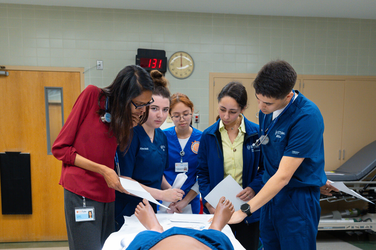 Various Health Students around an Operating Table