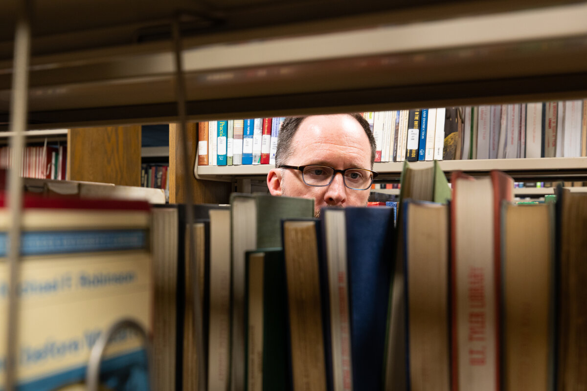 An inquisitive man looking at books