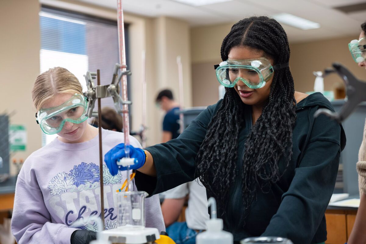 Two girls working in a chemistry lab