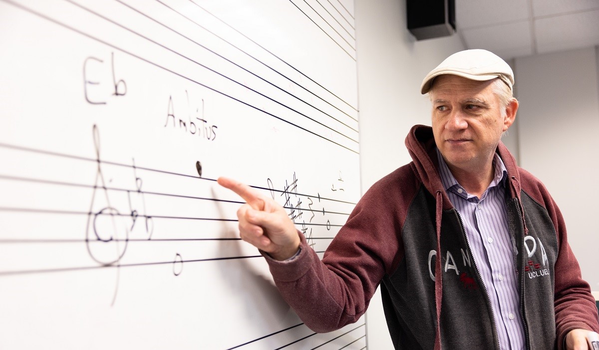 Teacher presenting music notes on a board