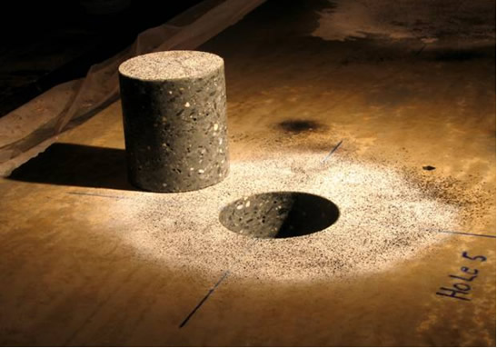 Photograph of a concrete plate and associated core after coring (visible is the pattern applied as part of the digital image correlation process)