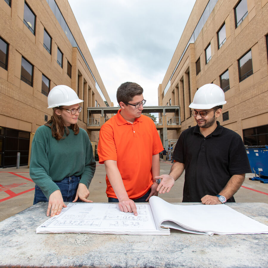 construction management students and professor at job site