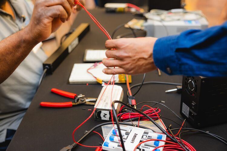 Electrical Engineering students working on a piece of equipment