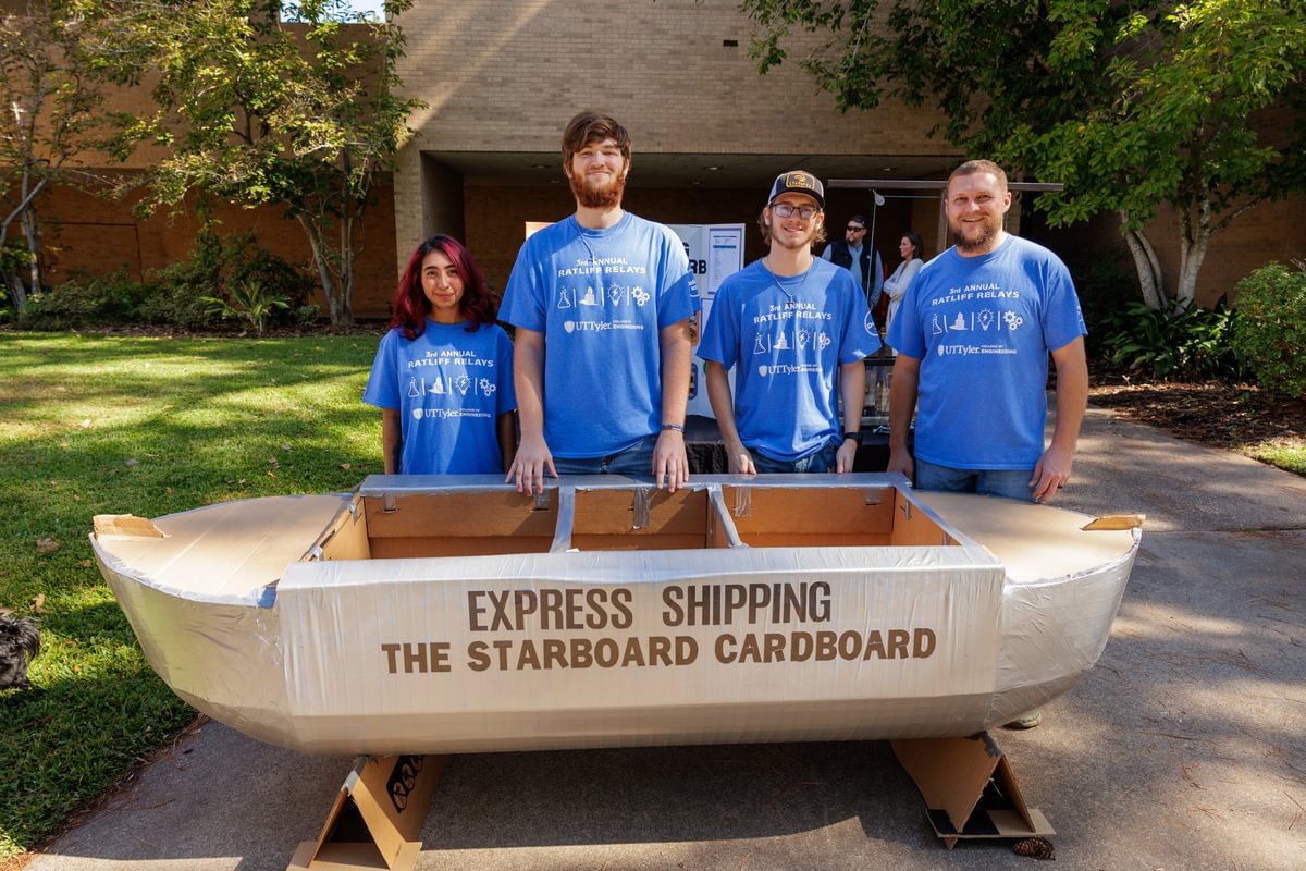 students with their cardboard canoe