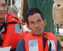 Shrimp fishermen listening to educational presentation.