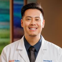 Dr. Giang in a white coat smiling