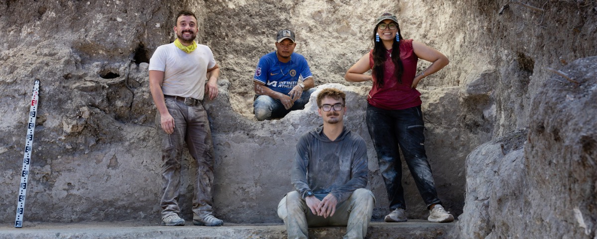 4 students pose during an excavation in Belize.