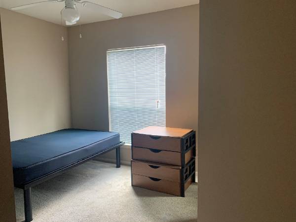 Bedroom with bed and window in rear