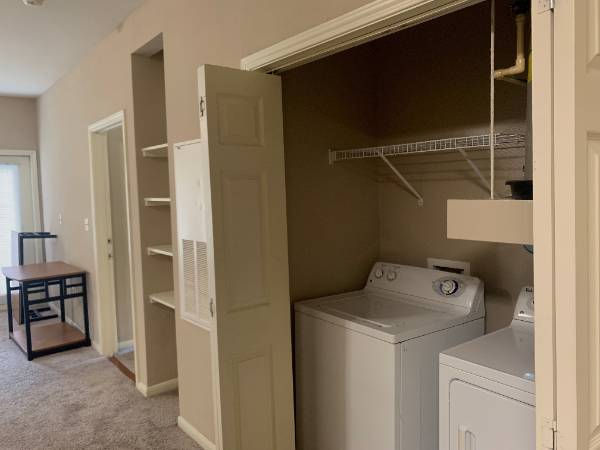 Washer and dryer sitting in corner of wall